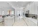 Bright modern kitchen featuring an island with quartz countertop, white cabinets, and stainless steel appliances at 3671 Summerwind Cir, Bradenton, FL 34209