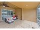 Enclosed patio area with tiled flooring, comfortable seating, and access to the home's interior at 3671 Summerwind Cir, Bradenton, FL 34209