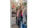 Organized walk-in closet with clothes, bags, and shoes displayed on shelves and racks at 3671 Summerwind Cir, Bradenton, FL 34209