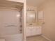 Well-lit bathroom featuring a shower-tub combo and a vanity with ample cabinet space at 3804 65Th E St, Bradenton, FL 34208