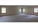 Spacious bedroom with multiple windows and carpet, offering ample natural light at 3804 65Th E St, Bradenton, FL 34208