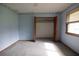 Cozy bedroom with carpet, blue walls, and ample closet space, offering a serene retreat at 3804 65Th E St, Bradenton, FL 34208