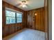 Cozy bedroom with wood paneled walls, window, ceiling fan and tile flooring at 3804 65Th E St, Bradenton, FL 34208