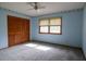 Bedroom with blue walls, closet, carpet, ceiling fan, and natural light through the window at 3804 65Th E St, Bradenton, FL 34208