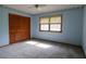 Bedroom with closet, carpet, ceiling fan, and natural light through the window at 3804 65Th E St, Bradenton, FL 34208