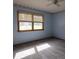 Bedroom with carpet flooring, ceiling fan, window, and light blue walls at 3804 65Th E St, Bradenton, FL 34208