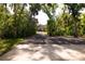 Long driveway through lush tropical trees and foliage leading to a charming home at 3804 65Th E St, Bradenton, FL 34208