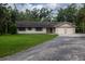 Charming single-story home with a two-car garage, manicured lawn, and gravel driveway at 3804 65Th E St, Bradenton, FL 34208