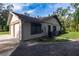 Side view of the house, featuring an attached two-car garage, side entry door, and grassy yard at 3804 65Th E St, Bradenton, FL 34208