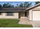 Close-up of the front entrance of the home, featuring a double door entry and attached two-car garage at 3804 65Th E St, Bradenton, FL 34208