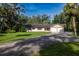 Single-story home with an attached two-car garage, a well-kept lawn, and a long driveway at 3804 65Th E St, Bradenton, FL 34208