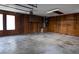Attached garage featuring wood paneling, concrete floors and natural light at 3804 65Th E St, Bradenton, FL 34208