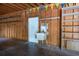 Attached garage featuring wood construction, concrete floors, utility sink and shelving at 3804 65Th E St, Bradenton, FL 34208