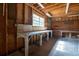 Attached garage featuring wood construction, concrete floors, and a large workbench at 3804 65Th E St, Bradenton, FL 34208