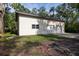 Spacious two-car garage with a clean concrete driveway and siding exterior, nestled among mature trees at 3804 65Th E St, Bradenton, FL 34208