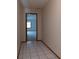 Hallway with tiled floor leading to carpeted bedroom, creating a transition between spaces at 3804 65Th E St, Bradenton, FL 34208