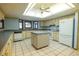 Spacious kitchen with a center island, white appliances, and tiled flooring at 3804 65Th E St, Bradenton, FL 34208