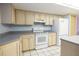 Functional kitchen with ample cabinet space, white appliances, and smooth countertops at 3804 65Th E St, Bradenton, FL 34208