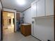 Convenient laundry room with storage cabinets and sink, adjacent to another room at 3804 65Th E St, Bradenton, FL 34208