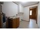 Spacious laundry area featuring a sink, storage cabinets and view into adjacent bedroom at 3804 65Th E St, Bradenton, FL 34208