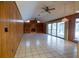 The living room boasts vaulted ceilings, wood paneling, fireplace, and sliding glass doors at 3804 65Th E St, Bradenton, FL 34208