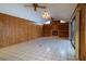 Living room features a ceiling fan, wood paneling, tile flooring, fireplace, and built-in shelving at 3804 65Th E St, Bradenton, FL 34208