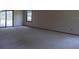 Bright living room with plush carpet and sliding glass doors leading to outdoor pool area at 3804 65Th E St, Bradenton, FL 34208