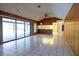 The living room features a ceiling fan, wood paneling, tile flooring, and access to kitchen at 3804 65Th E St, Bradenton, FL 34208