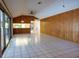 The living room features wood paneling, tile flooring, and access to a screened patio at 3804 65Th E St, Bradenton, FL 34208