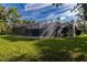 A screened-in pool area with mature trees, offering a private and relaxing outdoor space at 3804 65Th E St, Bradenton, FL 34208