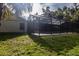 The screened-in pool area featuring tile decking, set against a backdrop of mature trees at 3804 65Th E St, Bradenton, FL 34208
