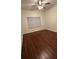 Modest bedroom with wood floors, blind covered window, and ceiling fan at 4207 S Dale Mabry Hwy # 6308, Tampa, FL 33611