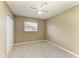 An empty bedroom with carpet, a closet and a window with blinds at 444 Flamingo Dr, Apollo Beach, FL 33572