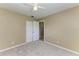 A tidy, empty bedroom with carpet, a closet and an open doorway at 444 Flamingo Dr, Apollo Beach, FL 33572