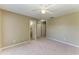 Large neutral bedroom with ensuite bathroom and ample closet space featuring carpet flooring at 444 Flamingo Dr, Apollo Beach, FL 33572