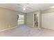Spacious bedroom with a large window, carpeted floor, ceiling fan, closet, and attached bathroom at 444 Flamingo Dr, Apollo Beach, FL 33572