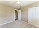 Bright bedroom featuring neutral walls, plush carpeting, and ample closet space at 444 Flamingo Dr, Apollo Beach, FL 33572