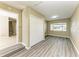 Bright and spacious bedroom featuring light gray floors, closet, and a window with blinds at 444 Flamingo Dr, Apollo Beach, FL 33572