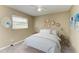Cozy bedroom featuring a ceiling fan, window with blinds, and tastefully decorated walls at 444 Flamingo Dr, Apollo Beach, FL 33572