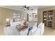 Open-concept living room with stylish furniture, tile flooring, and a view of the dining area at 444 Flamingo Dr, Apollo Beach, FL 33572