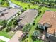 Stunning aerial view of a luxury home with tile roof, lush landscaping, and beautiful water views at 4540 Terrazza Ct, Bradenton, FL 34211