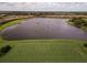 Scenic aerial view of a serene lake surrounded by lush greenery and well-maintained landscaping at 4540 Terrazza Ct, Bradenton, FL 34211