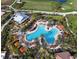 Aerial view showcases the expansive resort-style pool, palm trees, and verdant landscaping at 4540 Terrazza Ct, Bradenton, FL 34211