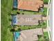 Aerial view of three homes featuring tile roofs, private pools, and well-maintained landscaping at 4540 Terrazza Ct, Bradenton, FL 34211