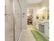 Bright bath features a white vanity, and a large glass shower with a view of a closet beyond at 4540 Terrazza Ct, Bradenton, FL 34211