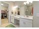 This bright bath features a double vanity, large mirror and a glass shower with an entrance to the closet at 4540 Terrazza Ct, Bradenton, FL 34211