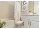 Bright bathroom featuring a shower-tub combination with decorative nautical art and a white vanity at 4540 Terrazza Ct, Bradenton, FL 34211