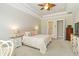 Light and airy bedroom featuring a tray ceiling, neutral tones and access to the bathroom at 4540 Terrazza Ct, Bradenton, FL 34211