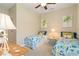 Twin beds with coastal theming in a bright bedroom with ceiling fan and neutral walls and flooring at 4540 Terrazza Ct, Bradenton, FL 34211