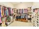 A custom walk-in closet features racks and shelving to keep everything organized in a bright space at 4540 Terrazza Ct, Bradenton, FL 34211
